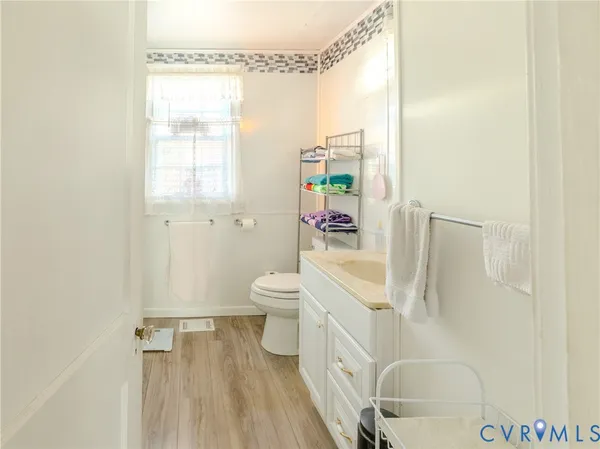 a white toilet sitting next to a bathroom sink