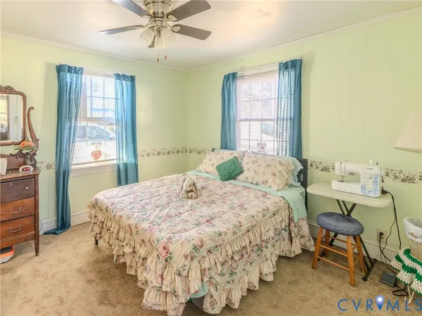 a bedroom with a bed and a table in it with window