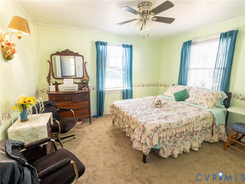 515 Ruthers Road Richmond, VA 23225 - Photo 23 of 34 a bedroom with a bed gym equipment and a large window