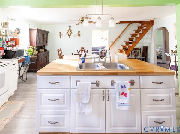 a kitchen with kitchen island a table and chairs