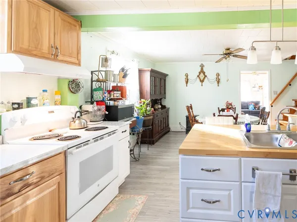 a kitchen with kitchen island sink stove and cabinets