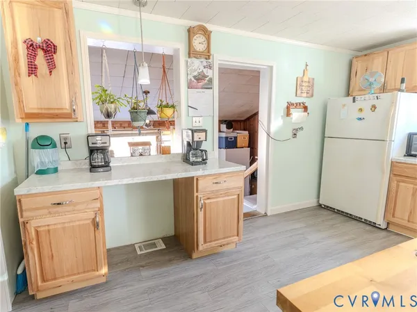 a kitchen with a refrigerator sink and white cabinets