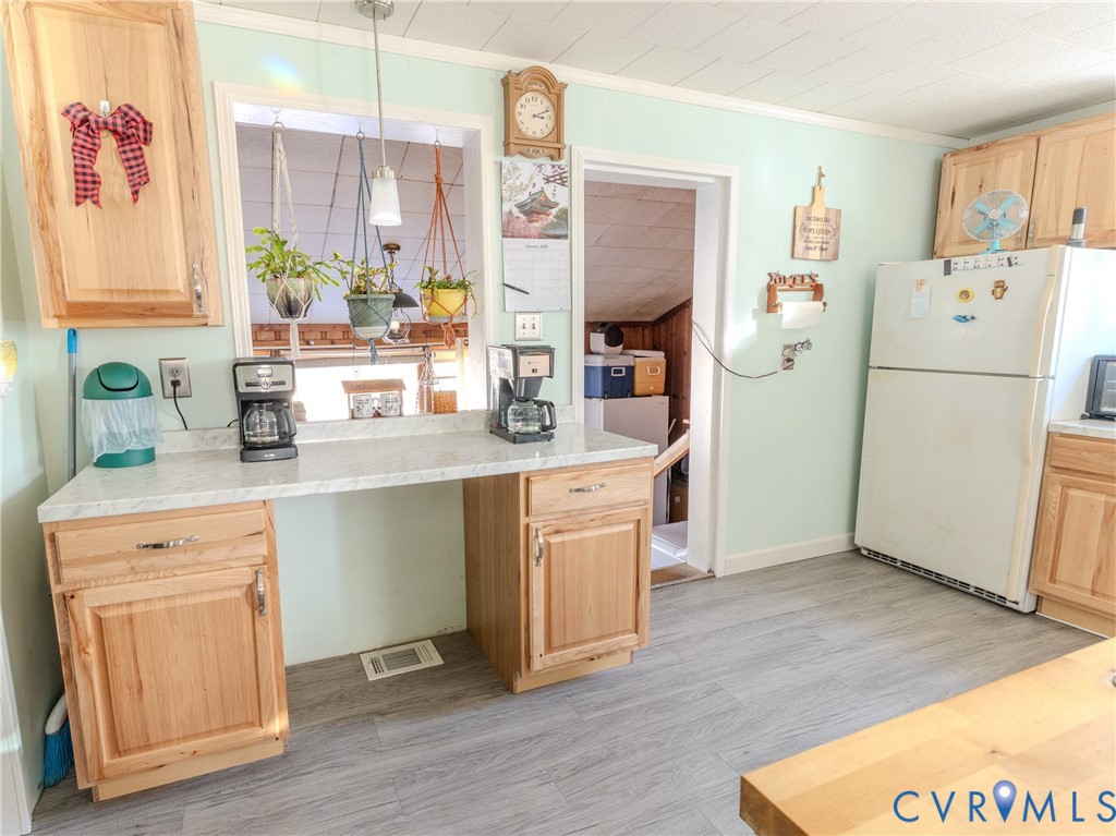 515 Ruthers Road Richmond, VA 23225 - Photo 9 of 34 a kitchen with a refrigerator sink and white cabinets