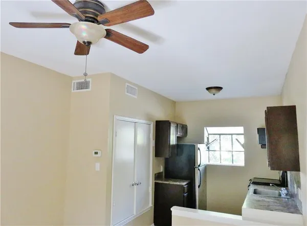 a kitchen with stainless steel appliances wooden floor dining table and chairs