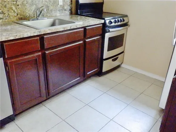 a kitchen with stainless steel appliances a sink and a microwave