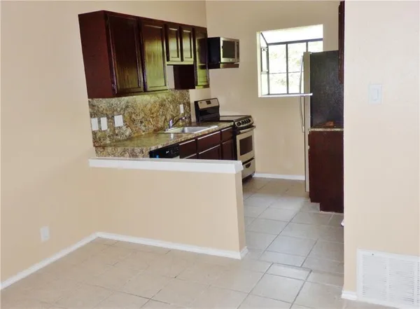 a kitchen with a stove and a microwave