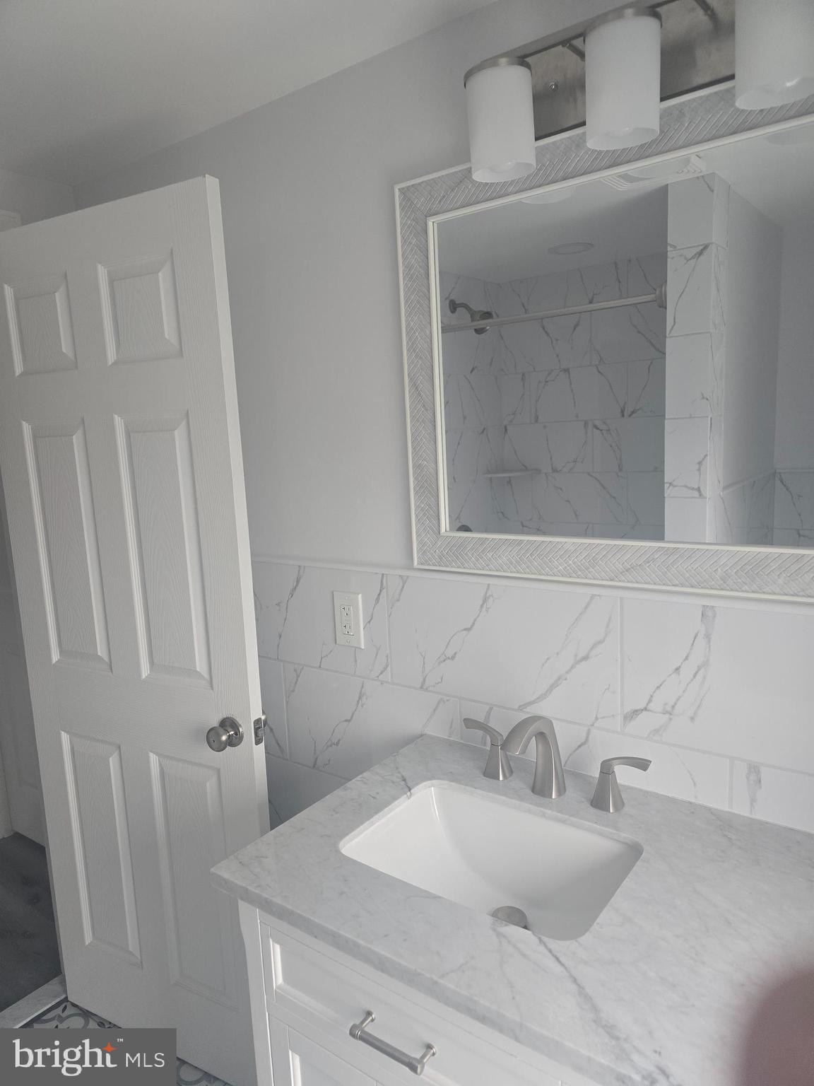 5925 Ridge Avenue, Unit 4 Philadelphia, PA 19128 - Photo 11 of 15 a bathroom with a sink and a mirror