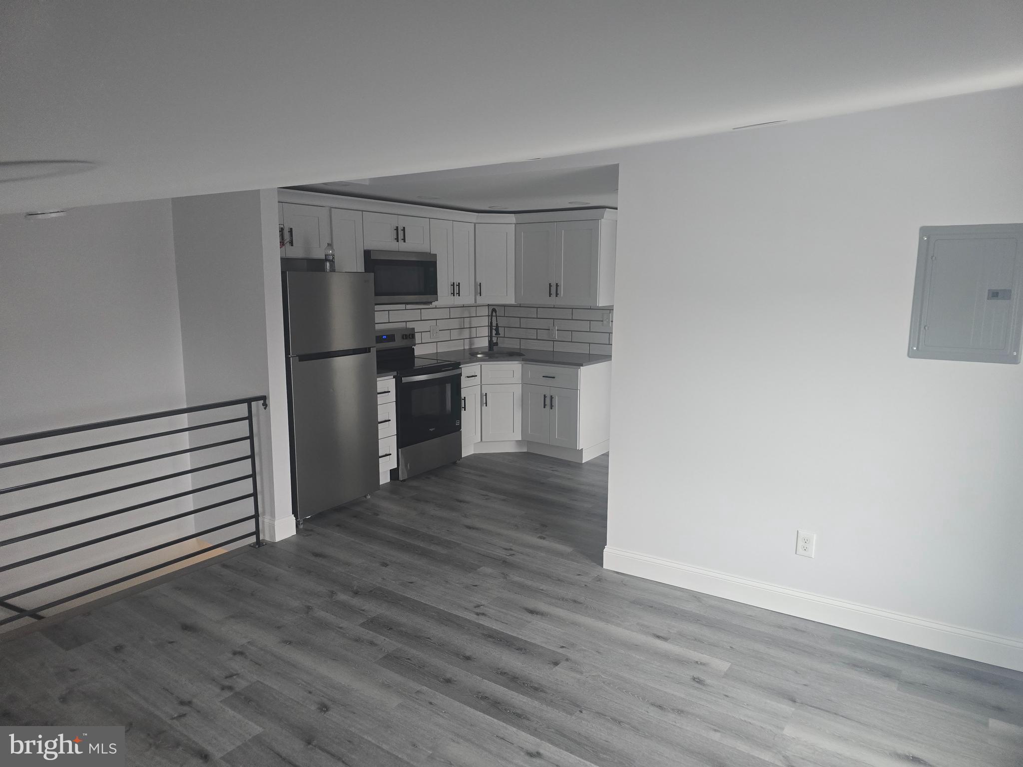 5925 Ridge Avenue, Unit 4 Philadelphia, PA 19128 - Photo 14 of 15 a kitchen with wooden floors and appliances