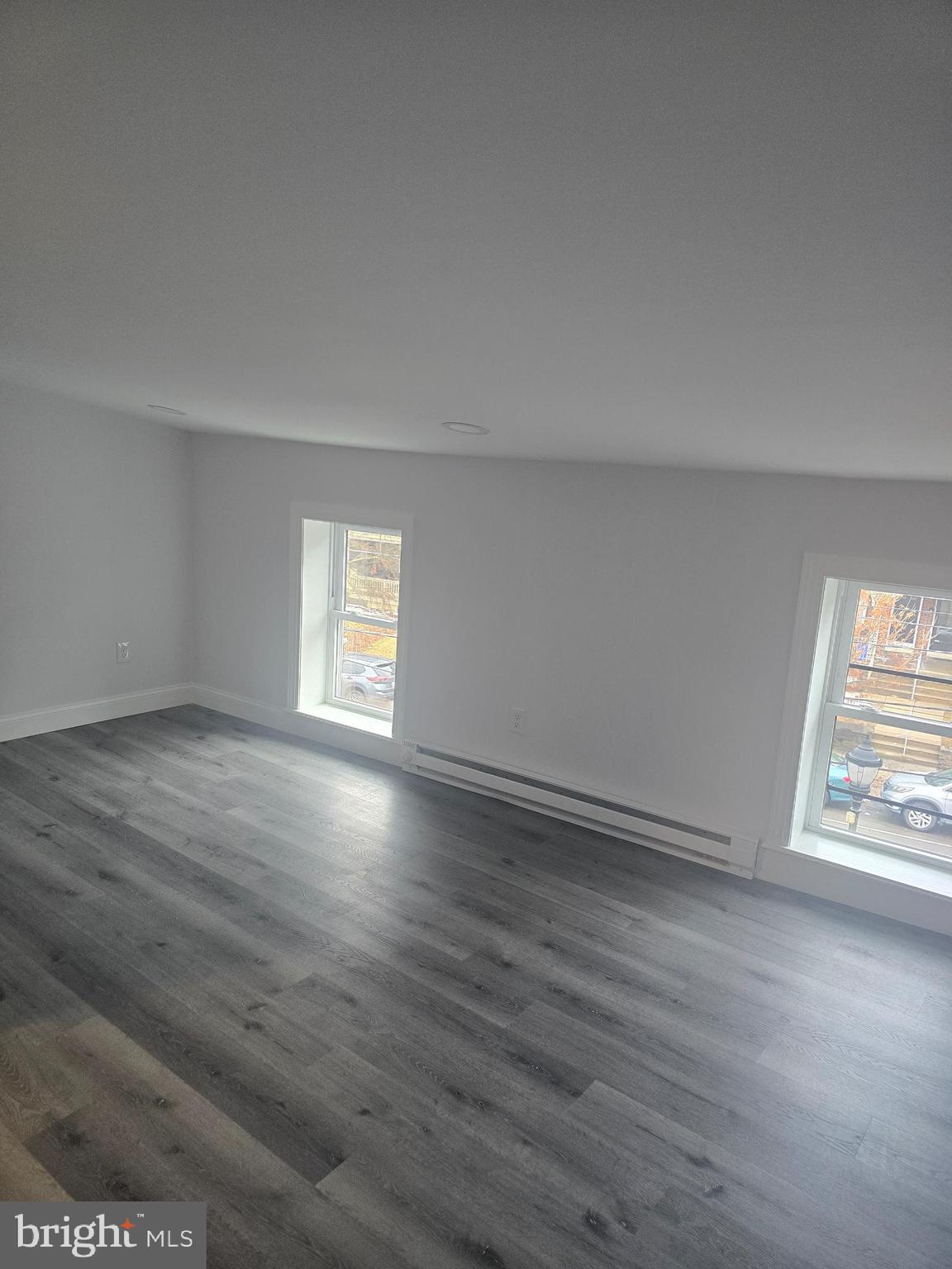 5925 Ridge Avenue, Unit 4 Philadelphia, PA 19128 - Photo 5 of 15 an empty room with wooden floor and windows