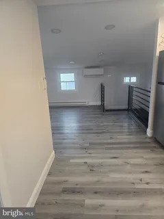 a view of a room with wooden floor and stairs
