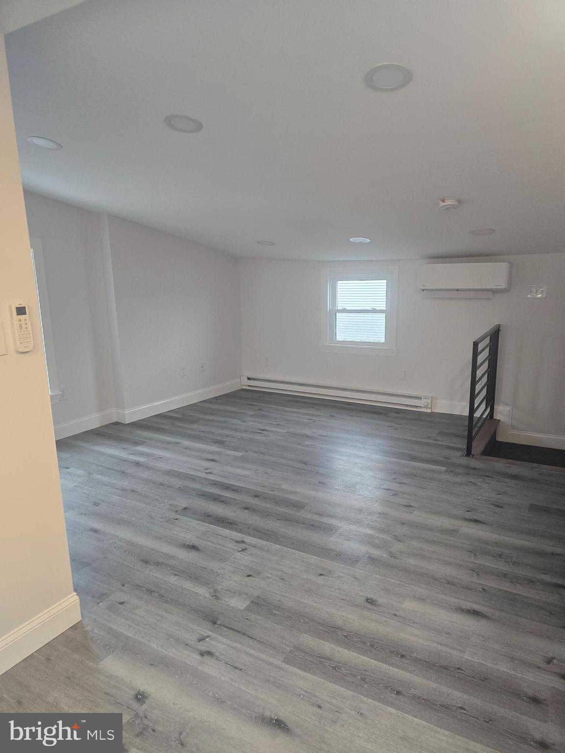 5925 Ridge Avenue, Unit 4 Philadelphia, PA 19128 - Photo 10 of 15 an empty room with wooden floor and windows
