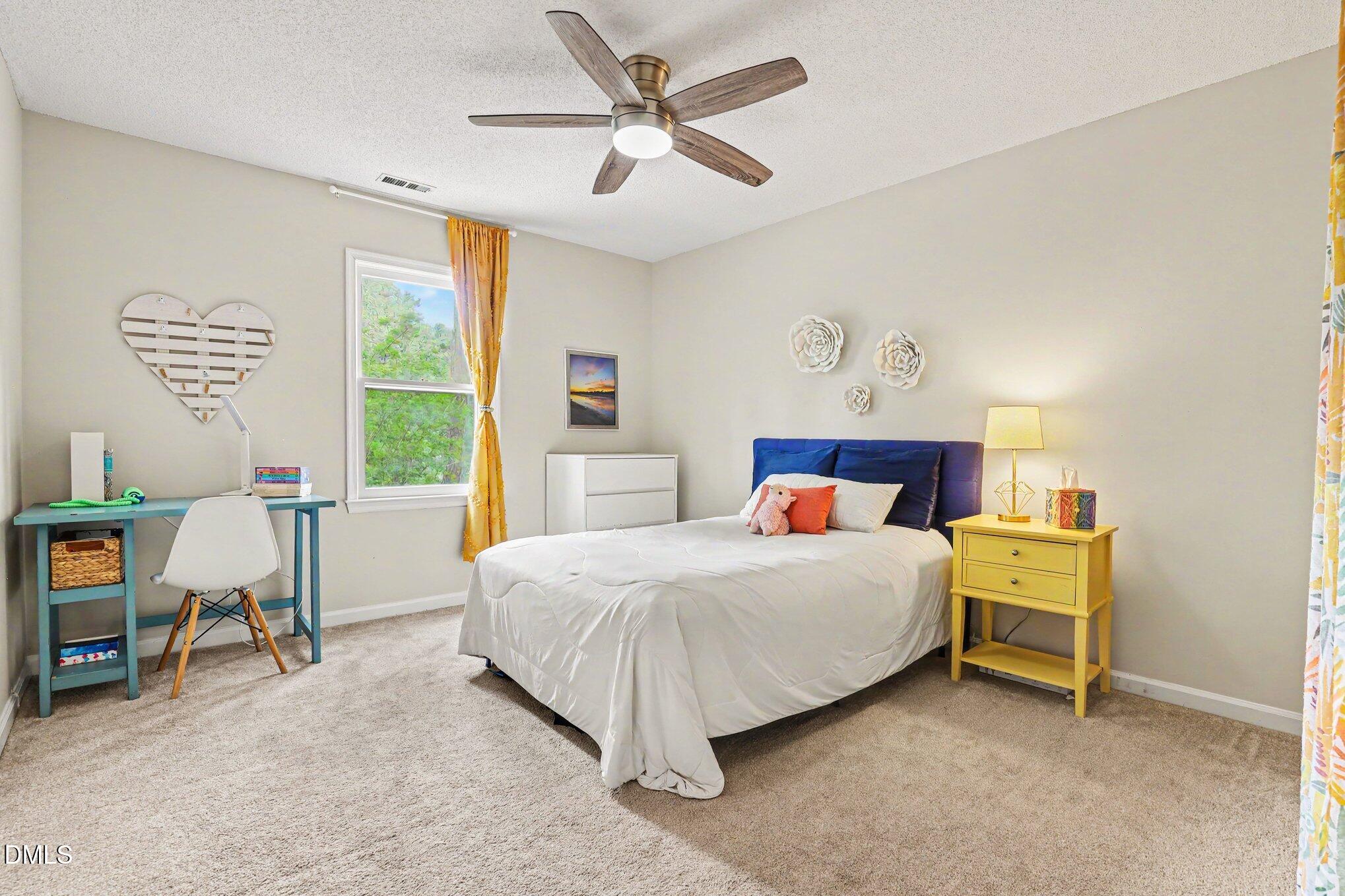 5468 Ingate Way Raleigh, NC 27613 - Photo 17 of 24 a bedroom with a bed and a window