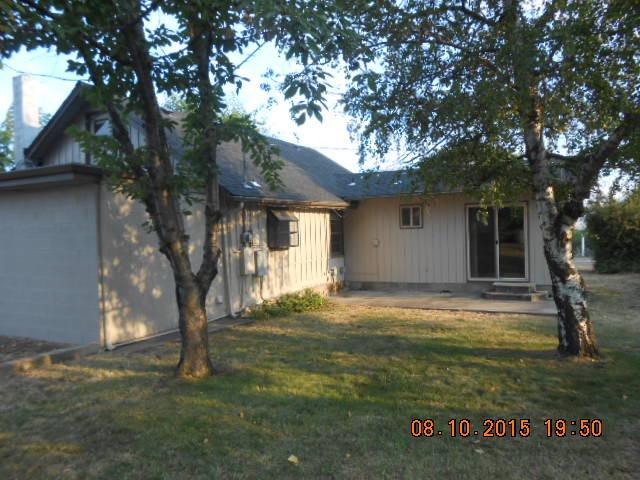 401 Foss Road Talent, OR 97540 - Photo 1 of 5 a backyard of a house with table and chairs