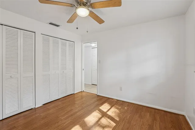 a view of empty room with wooden floor