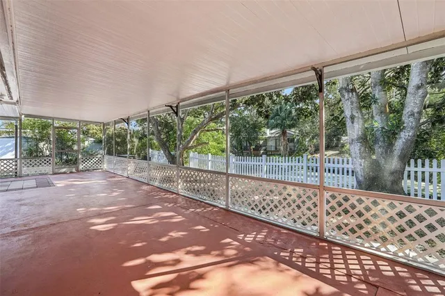 a view of a yard with wooden fence