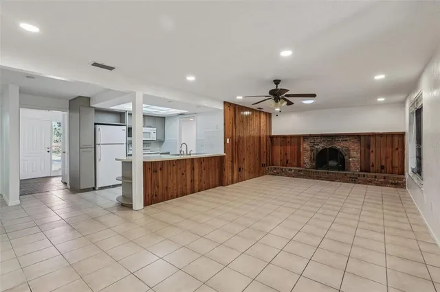 a view of a kitchen with a sink and a refrigerator in a kitchen