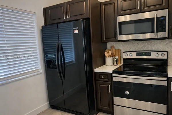 a kitchen with stainless steel appliances and cabinets
