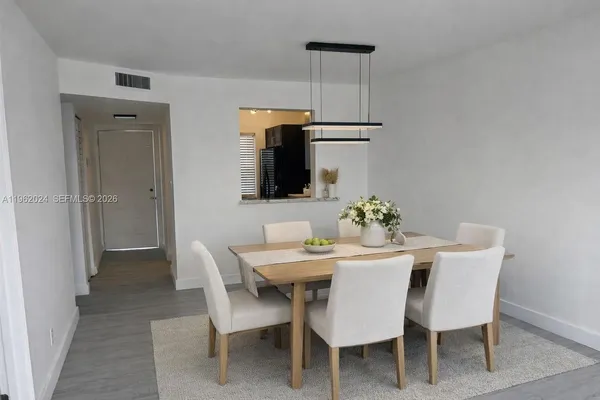 a dining room with furniture and window