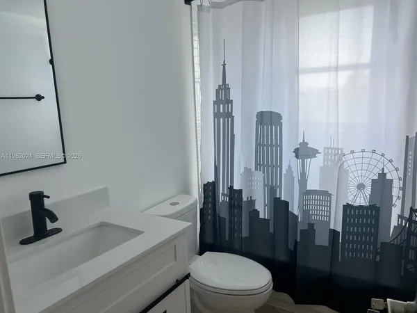 a bathroom with a toilet a sink and shower