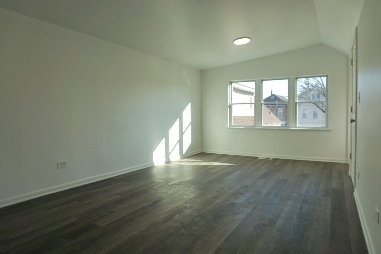 2502 West 46th Street, Unit 2 Chicago, IL 60632 - Photo 3 of 11 an empty room with wooden floor and windows