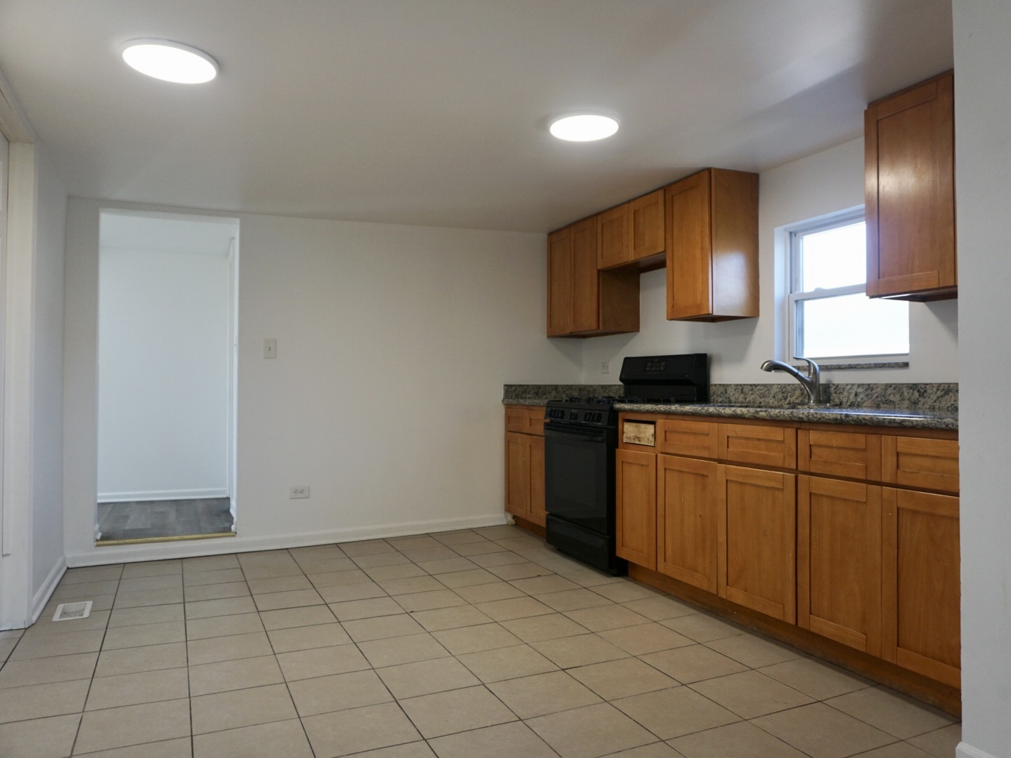2502 West 46th Street, Unit 2 Chicago, IL 60632 - Photo 4 of 11 a kitchen with a sink a stove top oven and cabinets