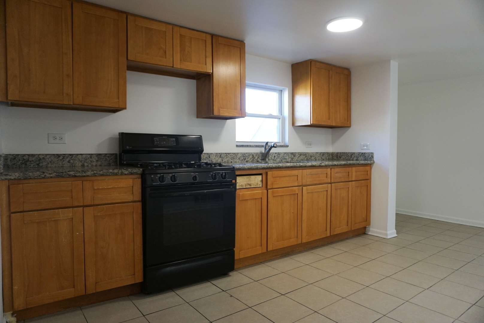 2502 West 46th Street, Unit 2 Chicago, IL 60632 - Photo 5 of 11 a kitchen with stainless steel appliances granite countertop a sink stove and cabinets