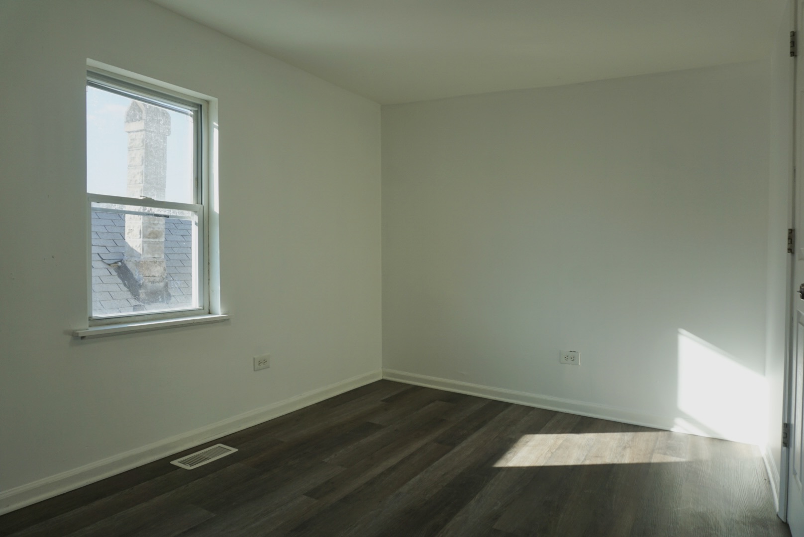 2502 West 46th Street, Unit 2 Chicago, IL 60632 - Photo 6 of 11 an empty room with wooden floor and windows