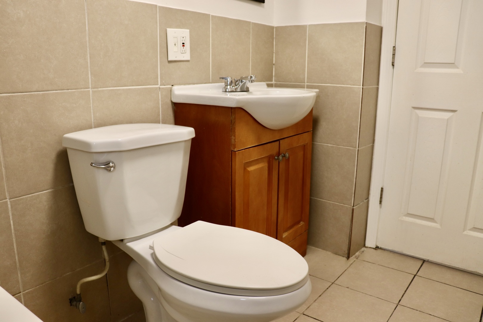 2502 West 46th Street, Unit 2 Chicago, IL 60632 - Photo 8 of 11 a bathroom with a sink a toilet and a mirror