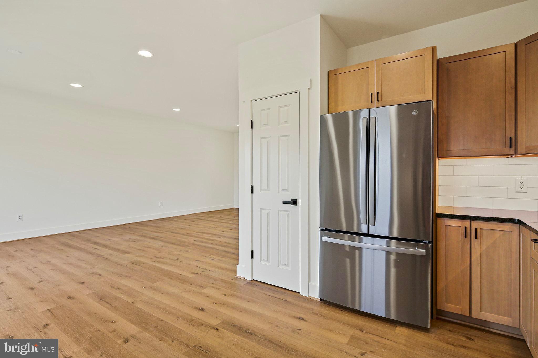 335 East Snyder Corner Road Red Lion, PA 17356 - Photo 11 of 34 a kitchen with stainless steel appliances wooden floor and wooden cabinets