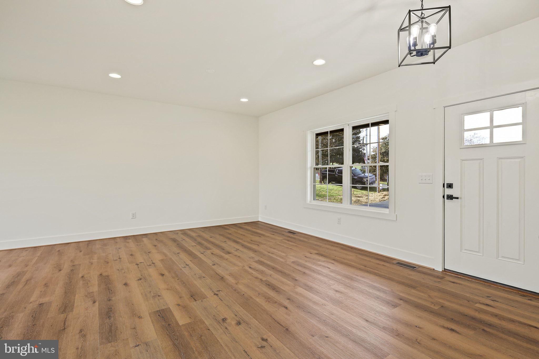 335 East Snyder Corner Road Red Lion, PA 17356 - Photo 4 of 34 wooden floor in an empty room with a window