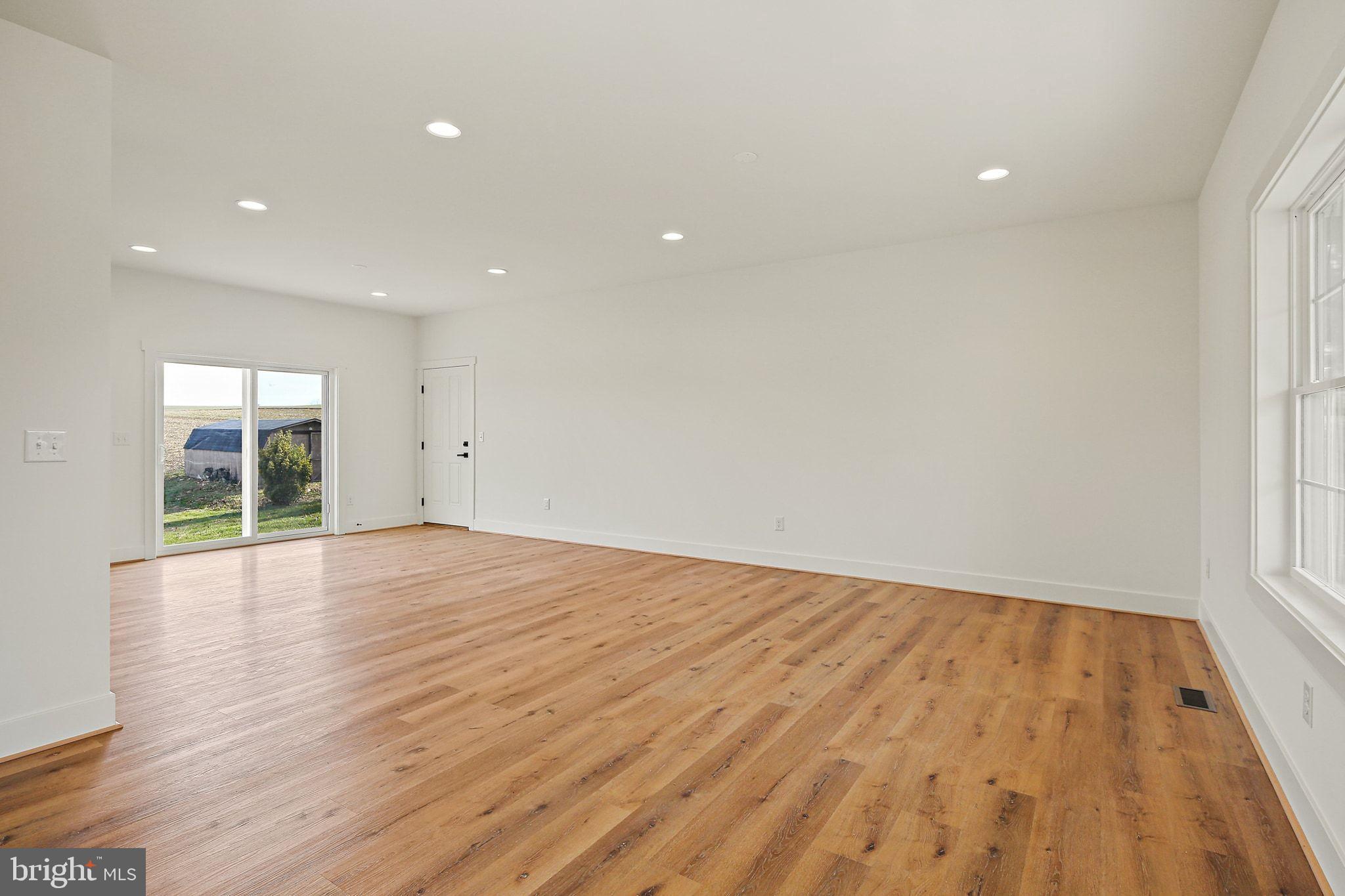 335 East Snyder Corner Road Red Lion, PA 17356 - Photo 8 of 34 a view of an empty room with wooden floor and a window