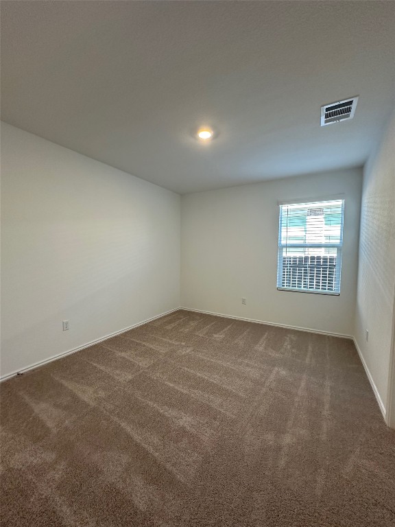 2513 Four Waters Loop Georgetown, TX 78628 - Photo 24 of 37 Empty room featuring dark carpet and baseboards
