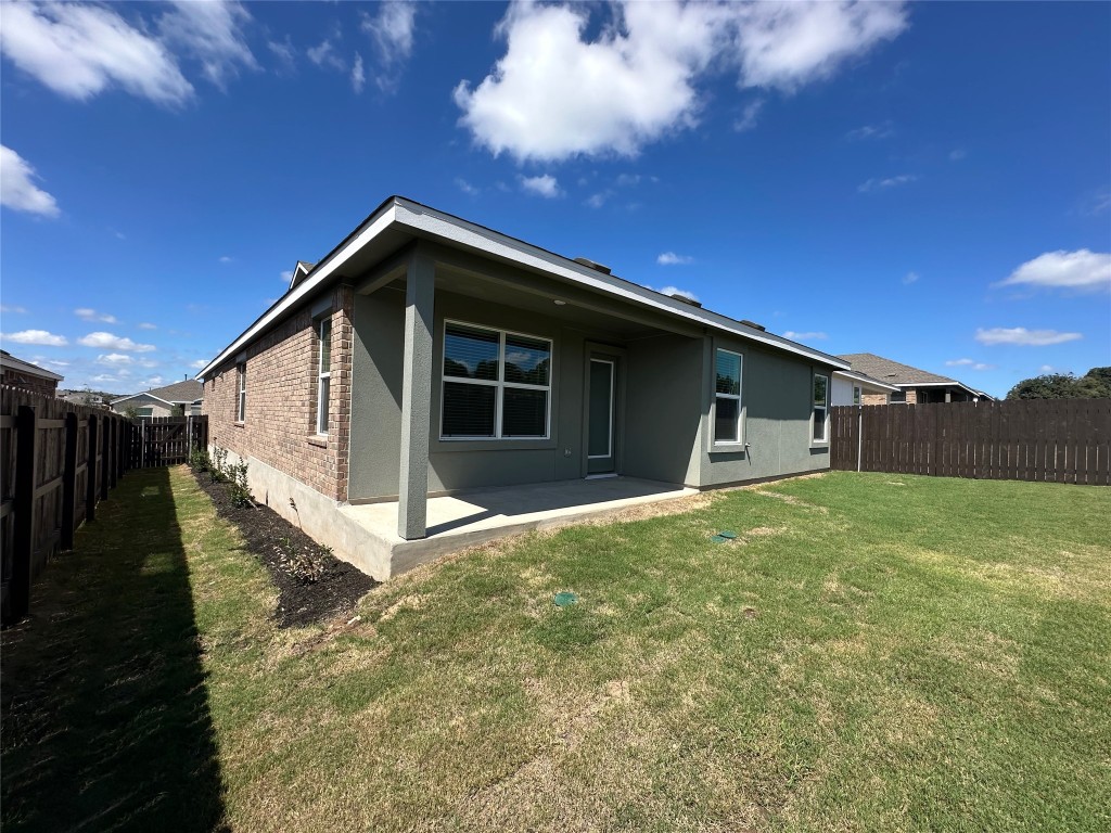 2513 Four Waters Loop Georgetown, TX 78628 - Photo 32 of 37 Back of property featuring a patio, a fenced backyard, brick siding, and stucco siding