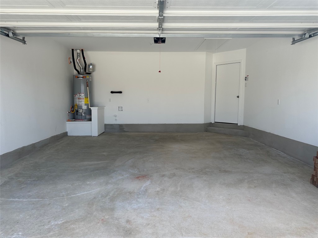 2513 Four Waters Loop Georgetown, TX 78628 - Photo 36 of 37 Garage featuring water heater and a garage door opener