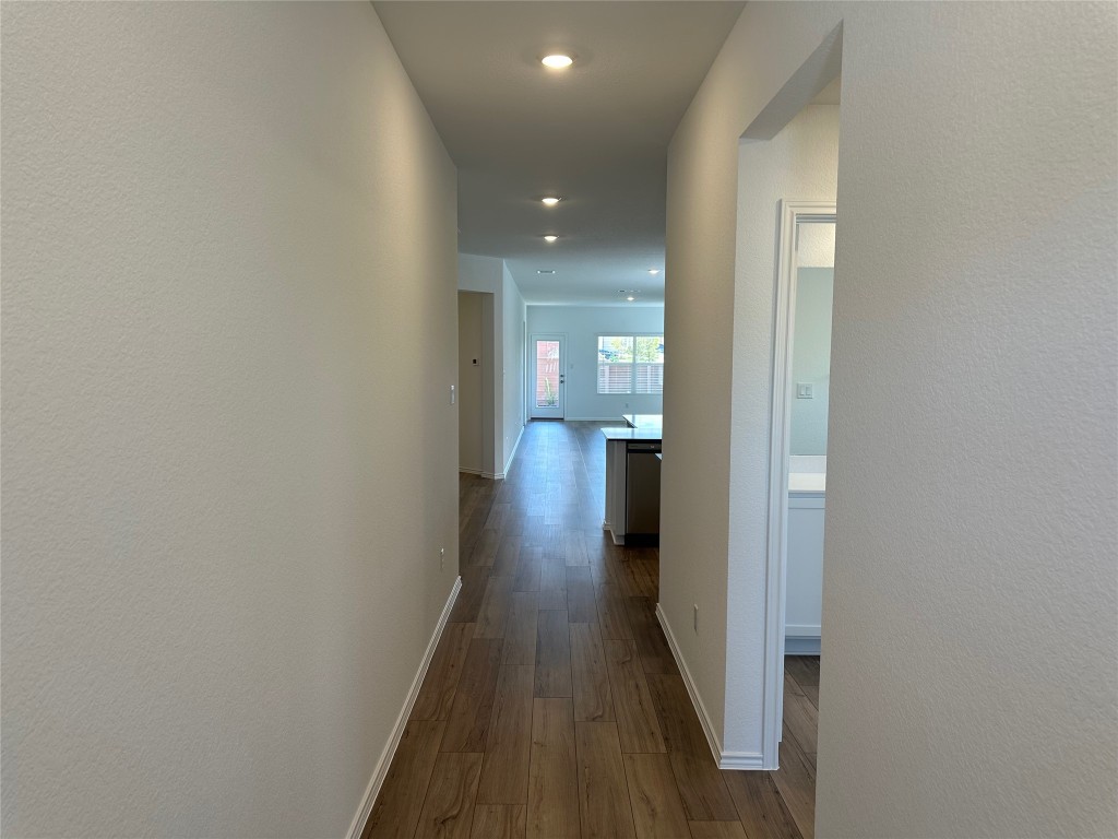 2513 Four Waters Loop Georgetown, TX 78628 - Photo 4 of 37 Hall featuring dark wood-style flooring and baseboards