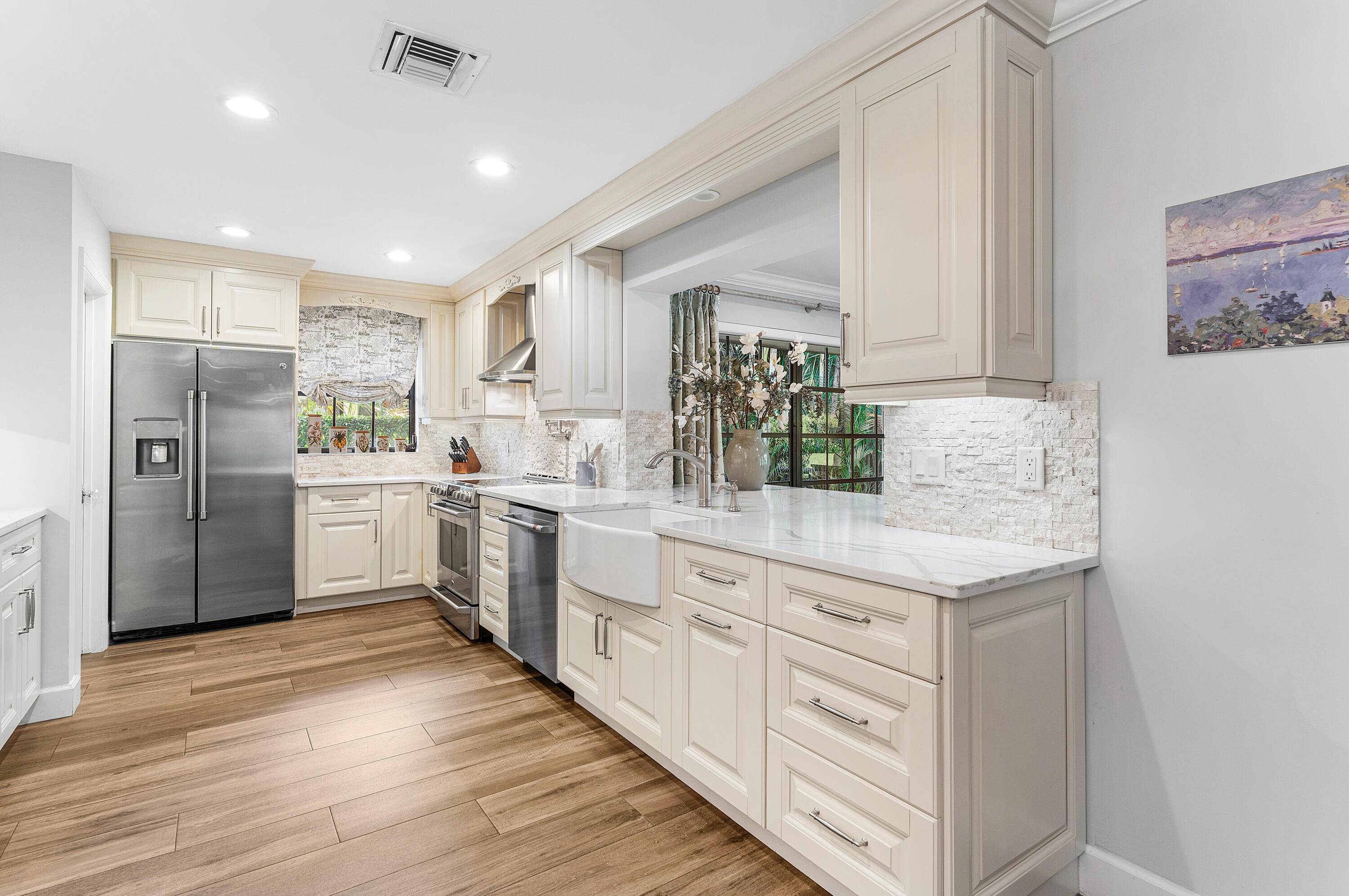 629 Cypress Key Circle Atlantis, FL 33462 - Photo 12 of 67 a kitchen with white cabinets and white appliances