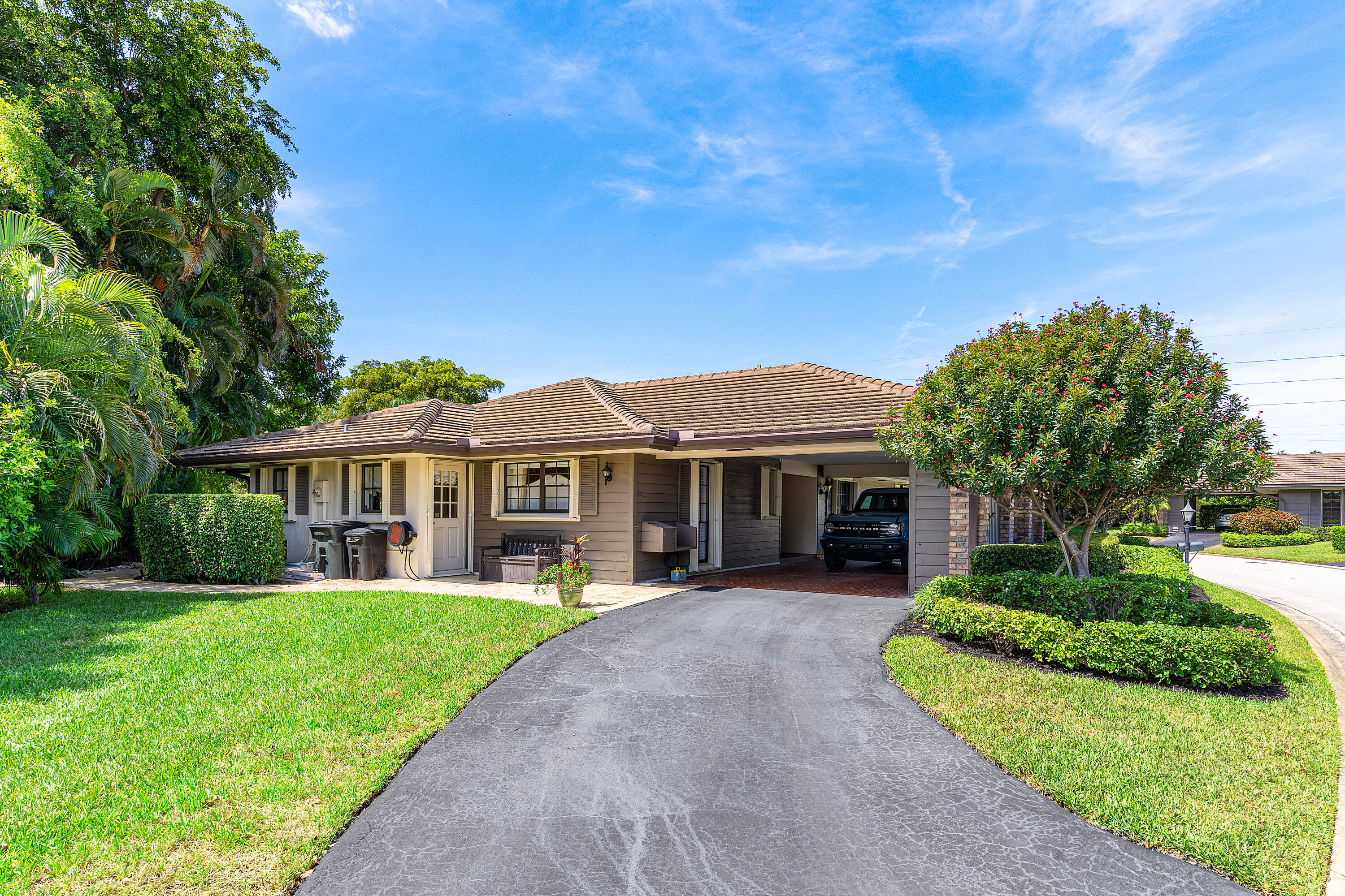 629 Cypress Key Circle Atlantis, FL 33462 - Photo 4 of 67 a front view of a house with a yard