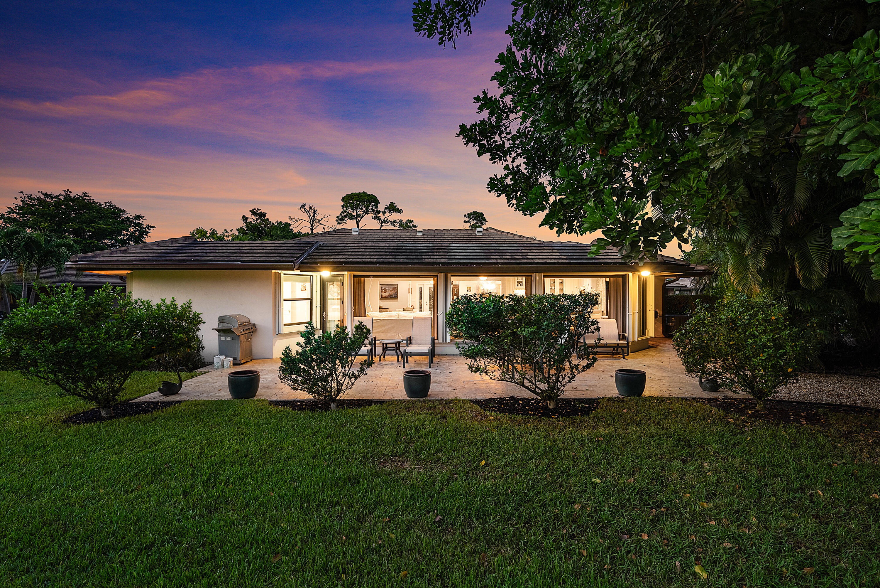 629 Cypress Key Circle Atlantis, FL 33462 - Photo 47 of 67 a view of a house with backyard sitting area and garden
