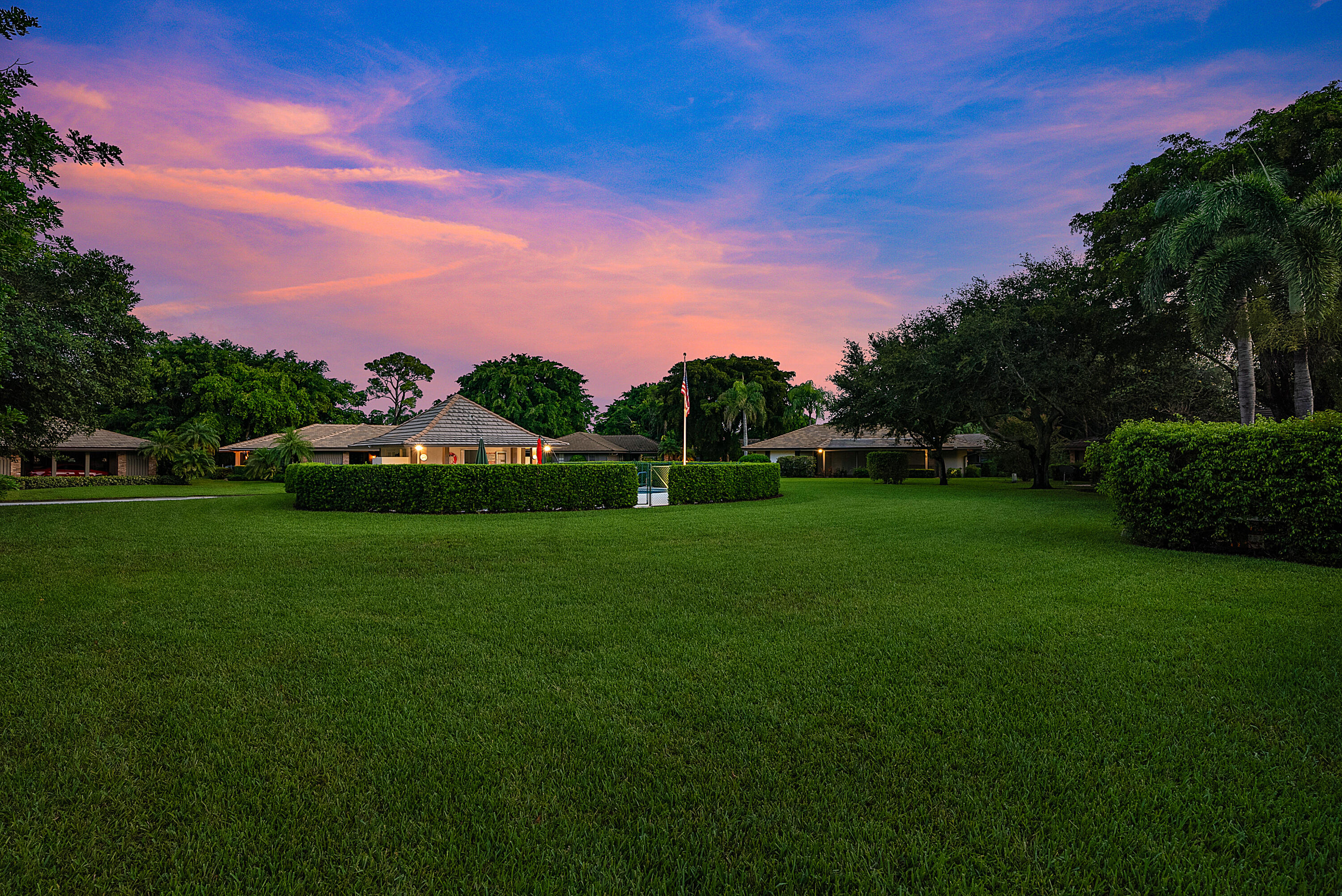 629 Cypress Key Circle Atlantis, FL 33462 - Photo 67 of 67 a front view of a house with a garden