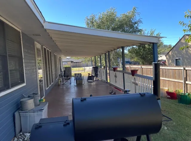 a view of a house with backyard porch and sitting area