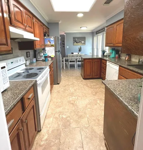 a kitchen with a sink a counter top space and appliances