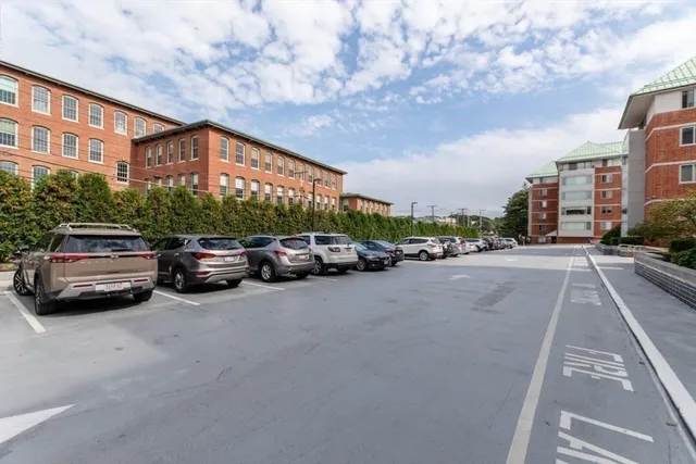 a city street lined with parked cars and buildings