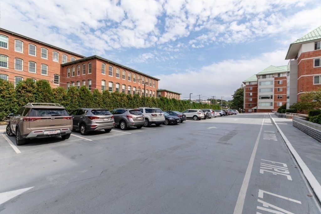 193 Oak Street, Unit 403 Newton, MA 02464 - Photo 14 of 21 a city street lined with parked cars and buildings