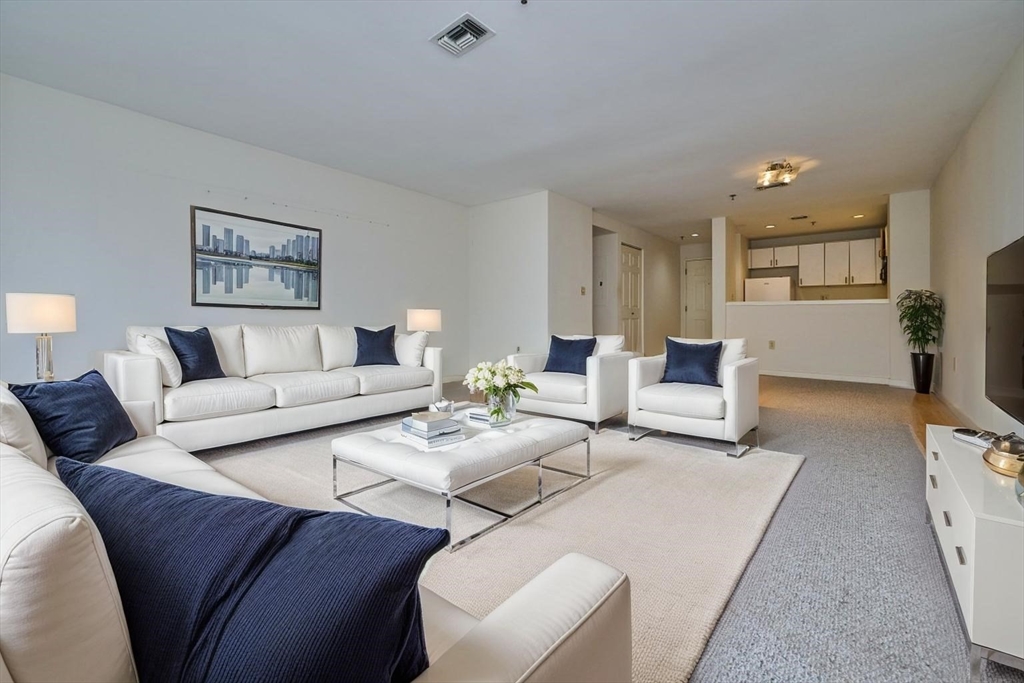 193 Oak Street, Unit 403 Newton, MA 02464 - Photo 2 of 21 a living room with furniture and a table