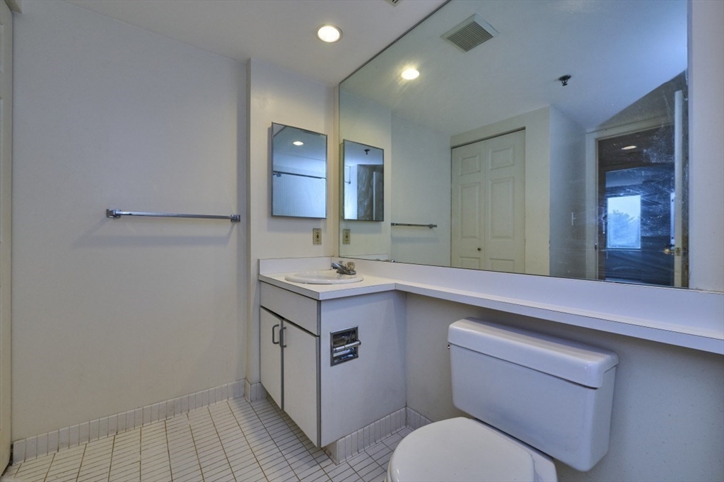 193 Oak Street, Unit 403 Newton, MA 02464 - Photo 5 of 21 a bathroom with a sink toilet and mirror