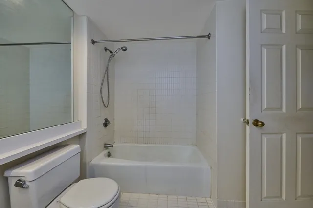 a bathroom with a shower a toilet and a bathtub