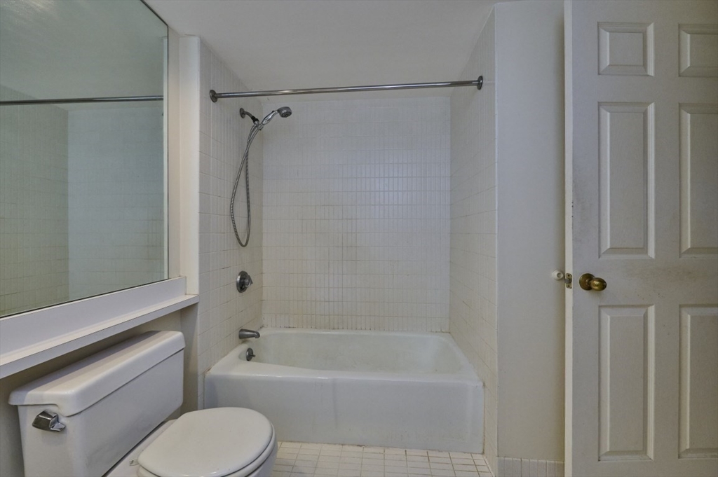 193 Oak Street, Unit 403 Newton, MA 02464 - Photo 6 of 21 a bathroom with a shower a toilet and a bathtub