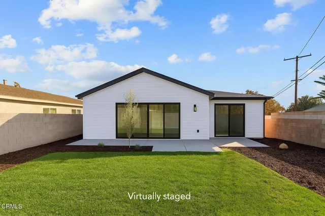 a front view of house with yard and outdoor seating