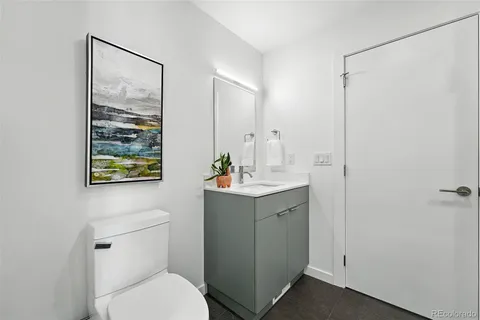a bathroom with a toilet a sink and mirror
