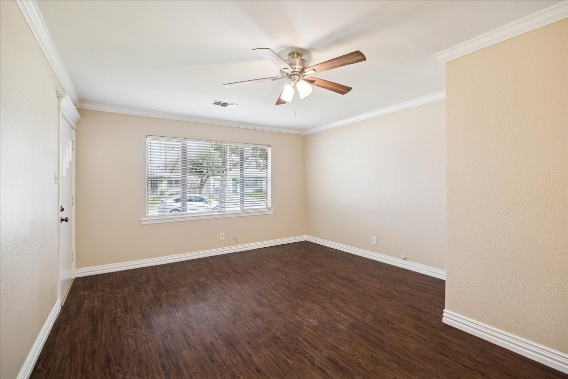 434 Meters Street Houston, TX 77020 - Photo 2 of 10 an empty room with wooden floor chandelier fan and windows